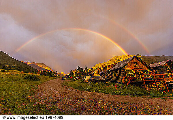 Rainbow over a cabin.