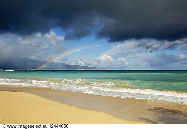 Rainbow over ocean and Baldwin Beach  on the North shore of Maui  Paia  Maui  Hawaii  United States of America