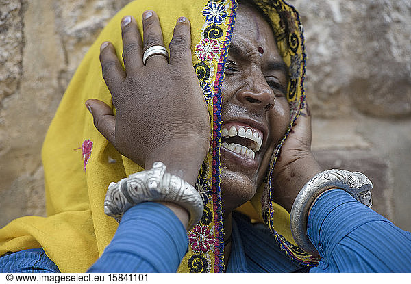 Rajasthan`s woman wearing traditional colorful clothing  laughing