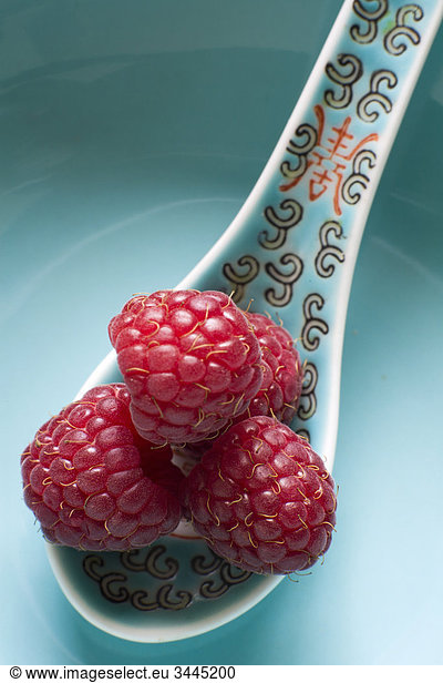 Raspberries on a turquoise plate  Sweden.