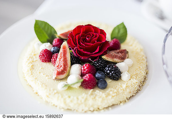 Raspberry cake decorated with blooming rose