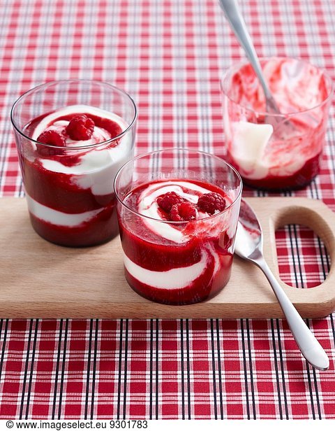 Raspberry swirl desserts garnished with fresh raspberries