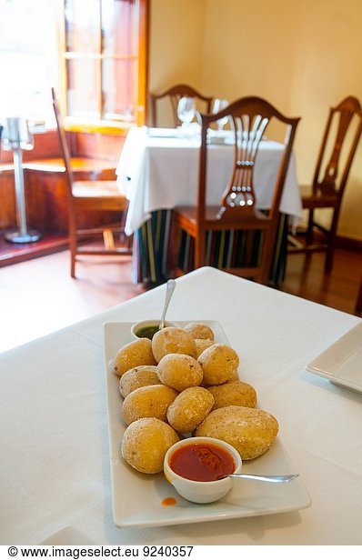 Ration of papas arrugadas with two mojo sauces in a Canarian restaurant. Madrid  Spain.
