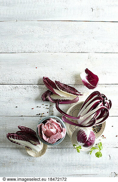 Raw radicchio lying on white wooden surface