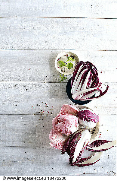 Raw radicchio lying on white wooden surface