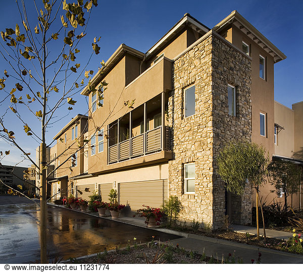 Rear of contemporary townhomes and garages