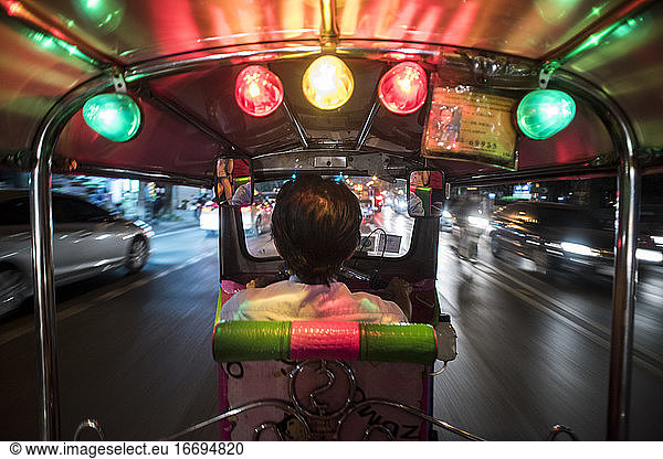 Rear view from a Tuk Tuk in montion in Bangkok  Thailand.