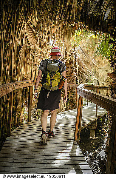 Rear view of a female hiker in the Coachella Valley National Wildlife Refuge.