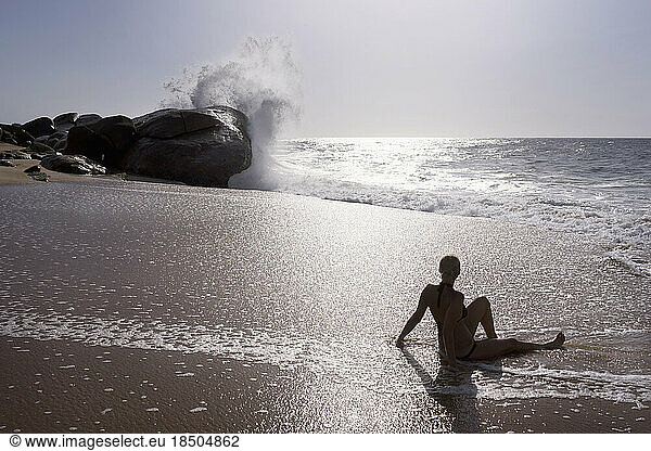 Rear view of a woman relaxing on the beach  Western Province  Sri Lanka
