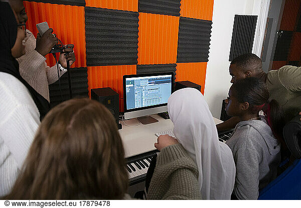 Rear view of artists working in recording studio