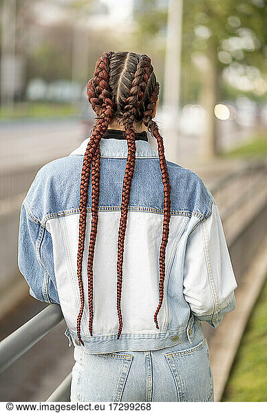 Rear view of beautiful woman with long braids