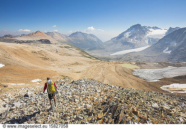 Rear view of hiker above Athelney Pass  British Columbia  Canada