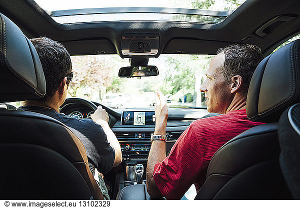 Rear view of homosexual couple travelling in car