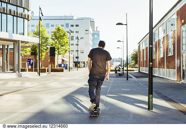 Rear view of man on skateboard