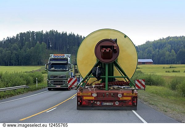 Rear view of oversize load transport by semi trailer of Peter-Star  Poland  passing a special transport truck on road. Salo  Finland - July 27  2018.