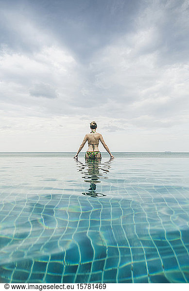 Rear view of woman in infinity pool  Koh Lanta  Thailand