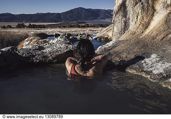 Rear view of woman relaxing in Bridgeport Hot Springs