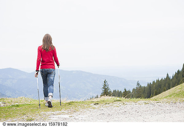 Rear view of woman with hiking poles