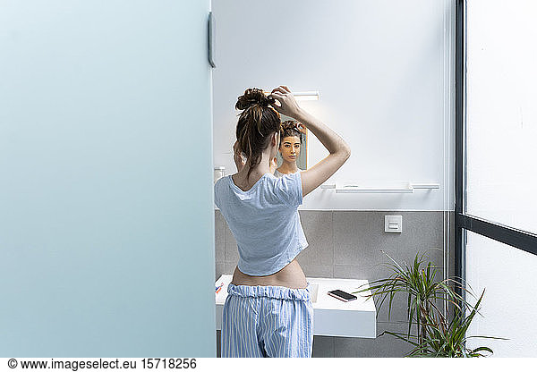 Rear view of young woman in bath room