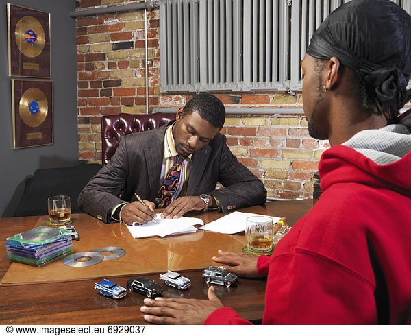 Record Executive Signing Papers for Hip Hop Artist