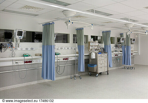 Recovery room outside the operating theatre in a hospital. Drapes  blue curtains around patient bays