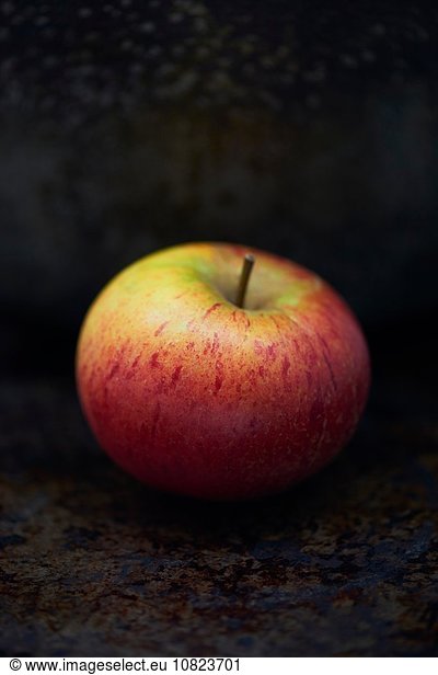 Red apple against dark background