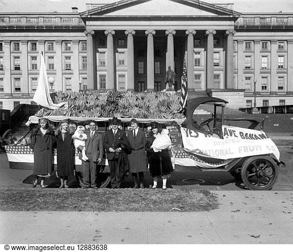 RED CROSS: BANANA AUCTION. A group of people from the American Red Cross posing in front of a truck where they are auctioning off bananas  Washington  D.C. Photograph  14 November 1925.