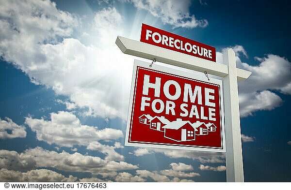 Red foreclosure home for sale real estate sign over beautiful clouds and blue sky