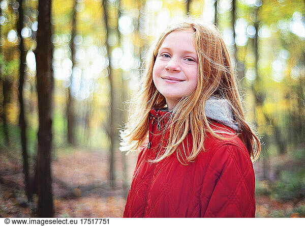 Red Haired Tween Girl Hiking in the Fall woods.