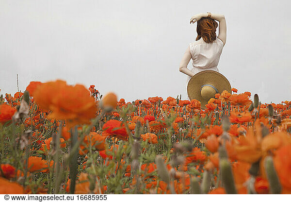 red haired woman in orange flowers