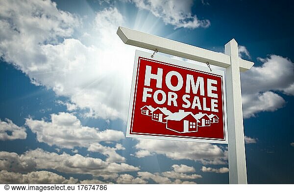 Red home for sale real estate sign over beautiful clouds and blue sky