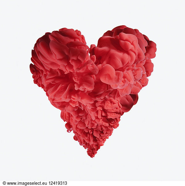 Red ink forming heart-shape on white background