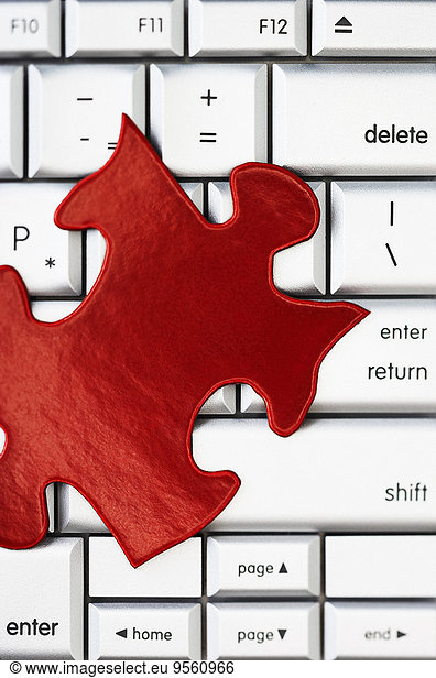 Red Puzzle Piece on Computer Keyboard