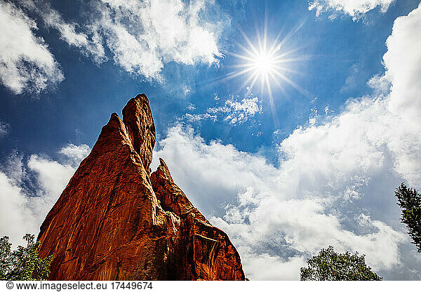 Red rocks cliff in summer sun burst