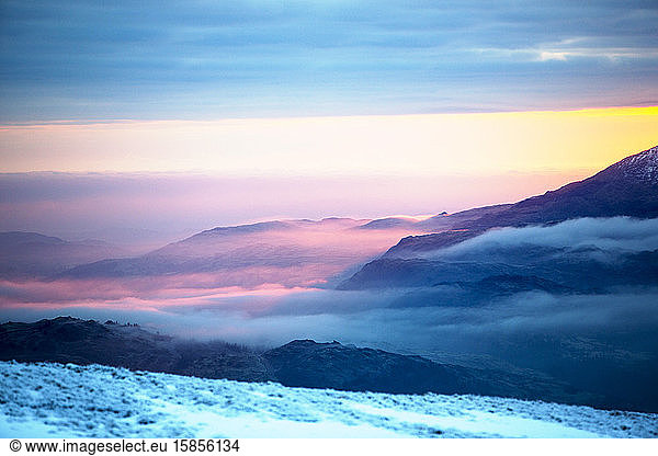 Red Screes above Ambleside with mist from a temperature inversion  Lake District  UK  looking towards Coniston Old Man.