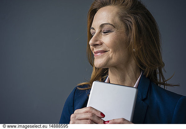 Redheaded businesswoman holding digital tablet