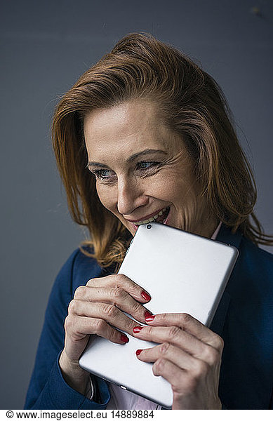 Redheaded businesswoman holding digital tablet