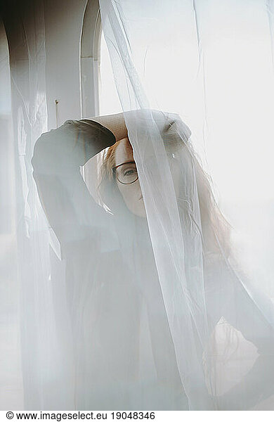 Redheaded Woman in front of Window