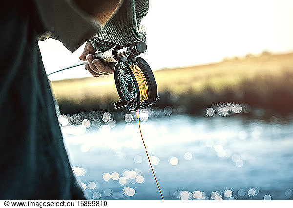 reel and rod of fly fisherman