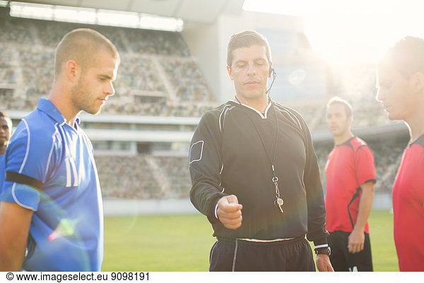 Referee tossing coin during soccer game