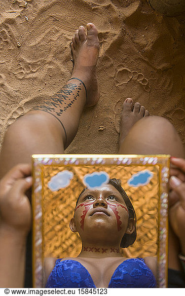 Reflection in a mirror of indigenous young woman