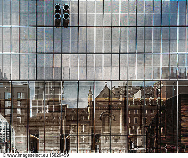 Reflection of old buildings in modern glass one in New York City  USA.