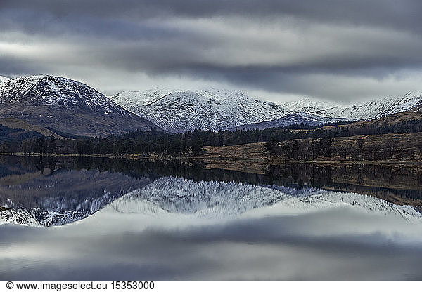 Reflection of snow capped mountains in lake  Scottish Borders  United Kingdom