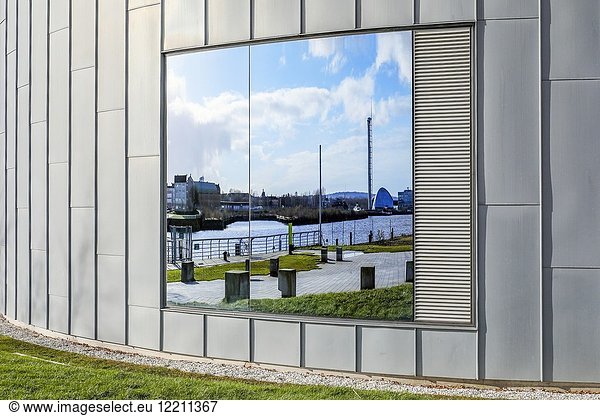 Reflection of the River Clyde  disused Govan docks and the science centre in the window of the Transport museum  Anderston  Glasgow  Scotland  UK.