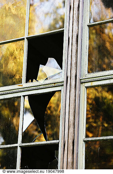 Reflections in broken windows at Lairds Landing  Tomales Bay  Point Reyes National Seashore  CA.