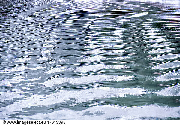 Reflections on the blue ripples of the calm waters of Glacier Bay; Glacier Bay National Park  Alaska  United States of America