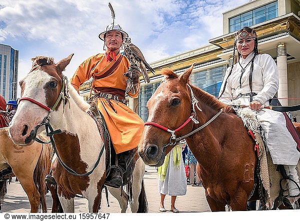 Reiten mit ausgebildetem Falken  der vor dem Parlamentsgebäude der Mongolei posiert  traditionelle Tracht  Stadt Ulaanbaatar  Mongolei  Asien