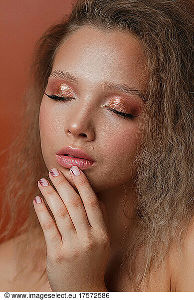Relaxed girl with beautiful manicure and makeup