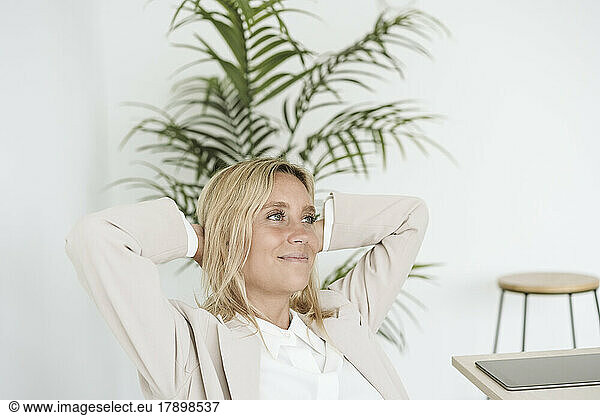 Relaxed smiling businesswoman in office