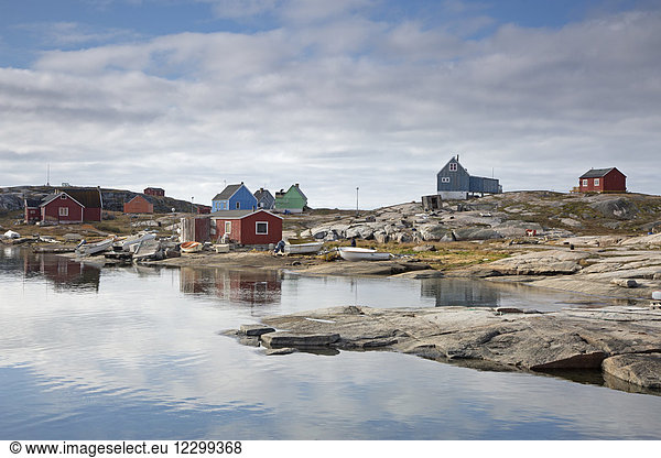 Remote fishing village at craggy waterfront Kalaallisut Greenland